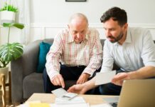 Offering Financial Help to an Elderly Loved One Without Making It Awkward Caring son doing the finances of his elderly father